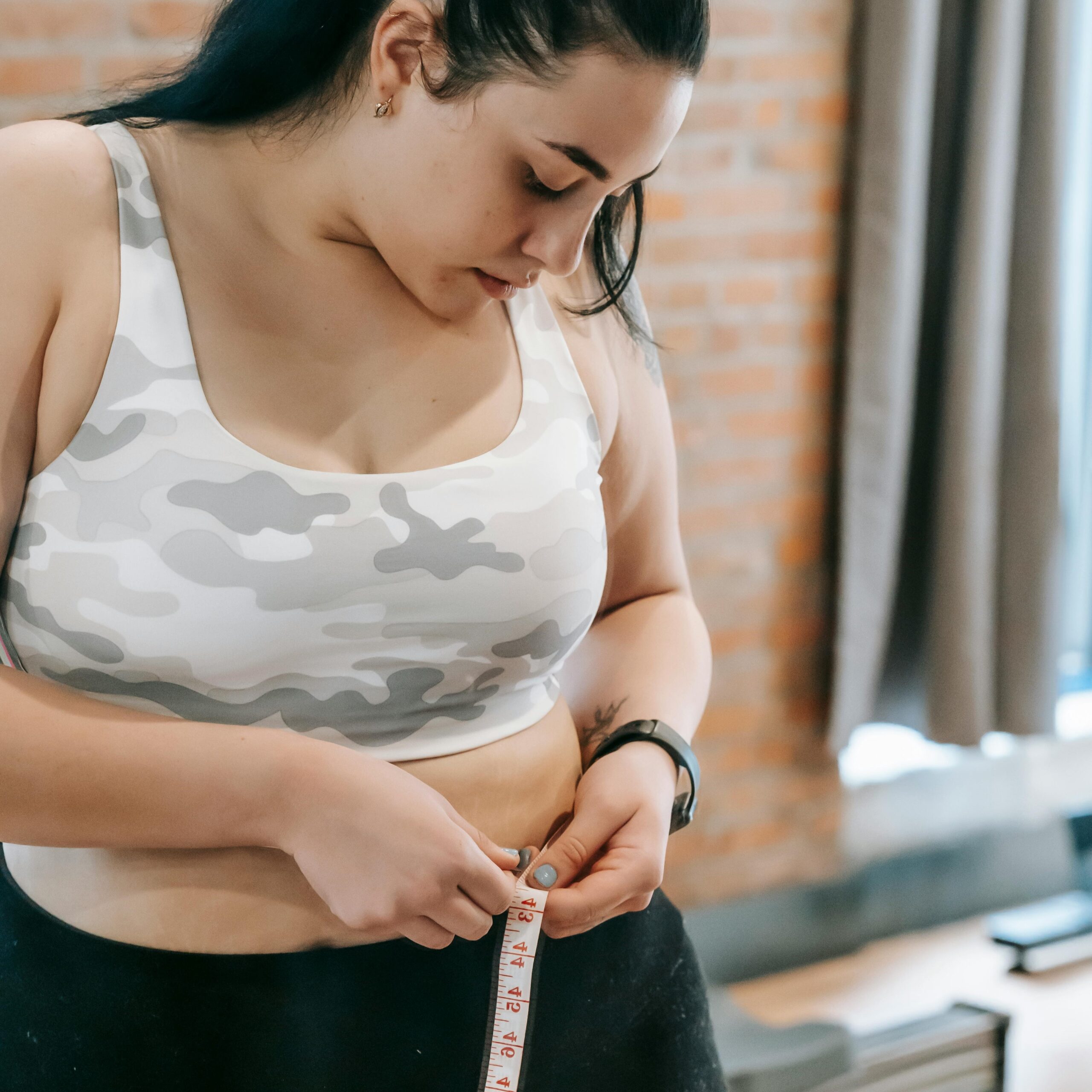 Photo by Andres Ayrton: https://www.pexels.com/photo/woman-measuring-waist-with-tape-in-gym-6551424/