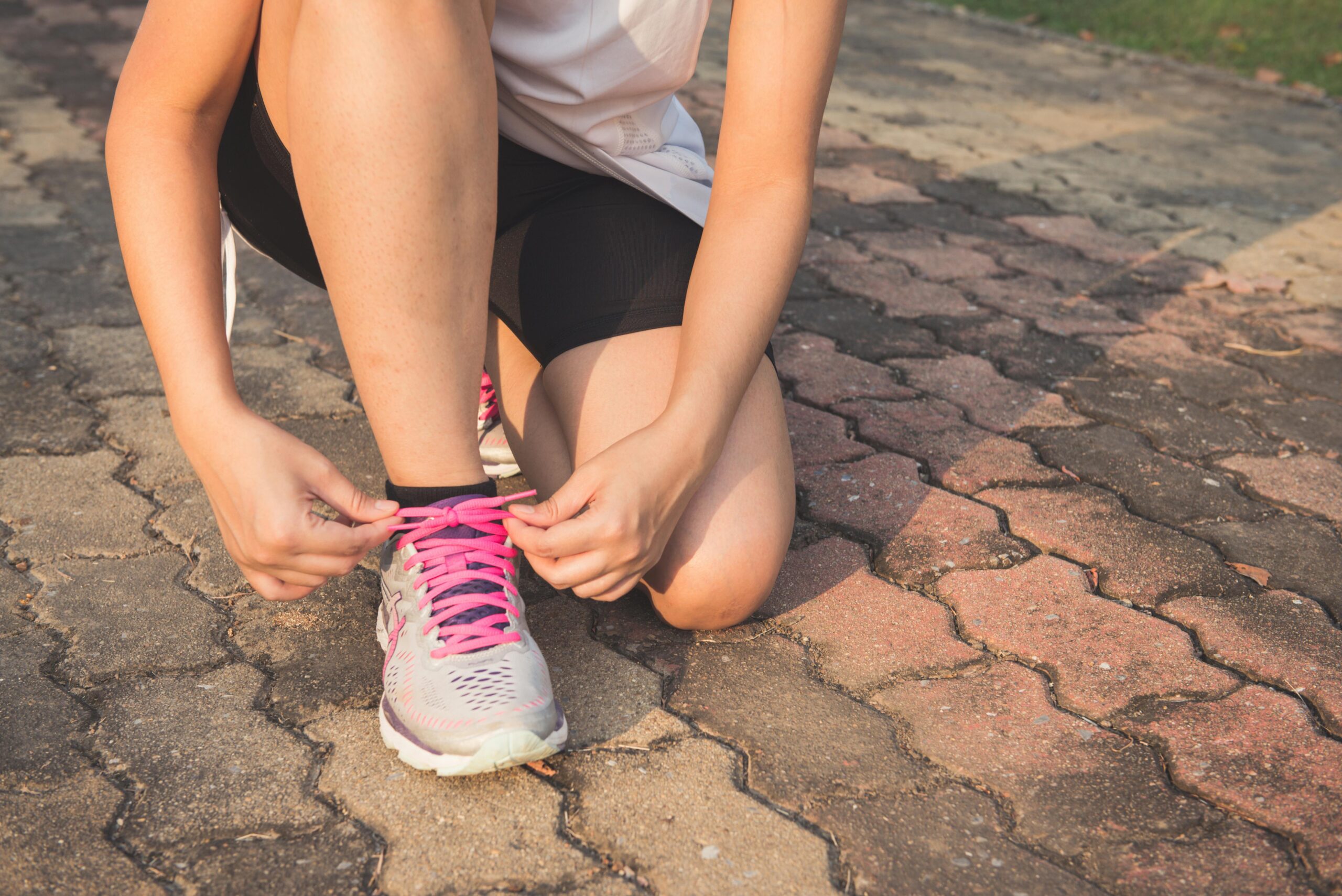 Photo by Tirachard Kumtanom: https://www.pexels.com/photo/woman-lacing-up-her-gray-and-pink-nike-low-top-athletic-shoe-601177/